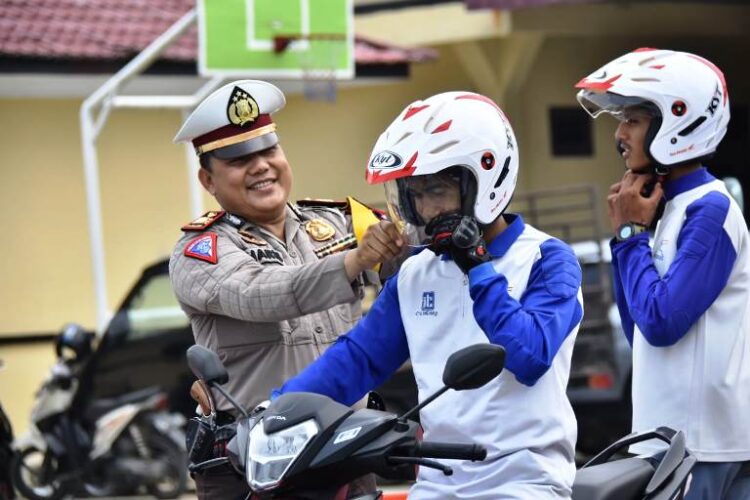 Kasat Polres Sergai AKP M Haris Saat memberikan pemahaman cara memakai perlengkapan kendaraan sepeda motor. (Sugiono)